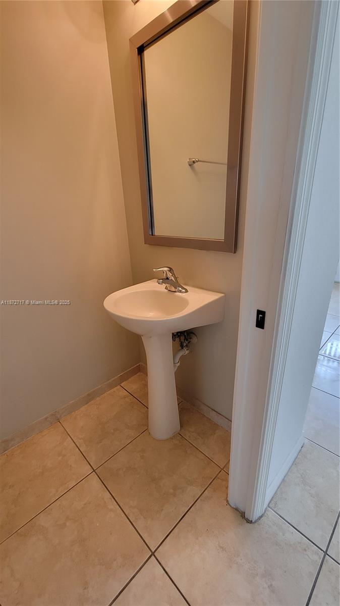 12600 Southwest 50th Court, Unit 437 Miramar, FL 33027 - Photo 11 of 28 a bathroom with a sink a toilet and mirror