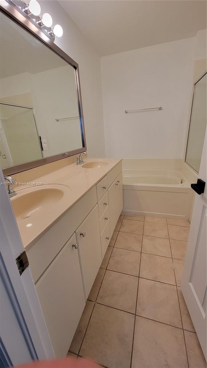 12600 Southwest 50th Court, Unit 437 Miramar, FL 33027 - Photo 23 of 28 a bathroom with a bathtub and a shower