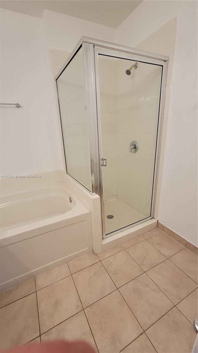 12600 Southwest 50th Court, Unit 437 Miramar, FL 33027 - Photo 24 of 28 a white bath tub sitting next to a shower