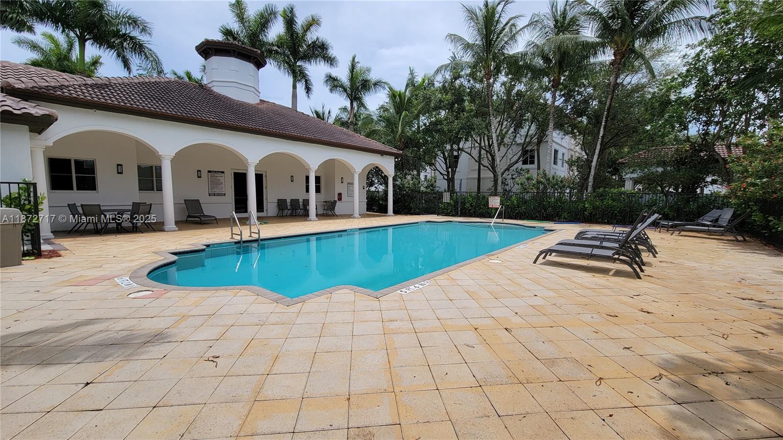 12600 Southwest 50th Court, Unit 437 Miramar, FL 33027 - Photo 28 of 28 a swimming pool with yard and outdoor seating