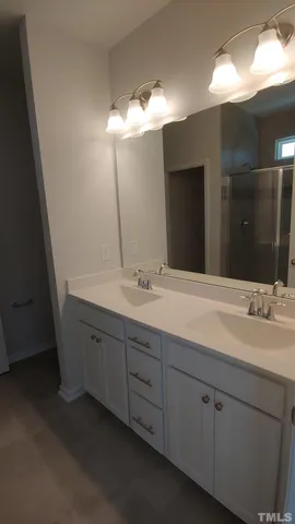 a bathroom with a double vanity sink and a mirror
