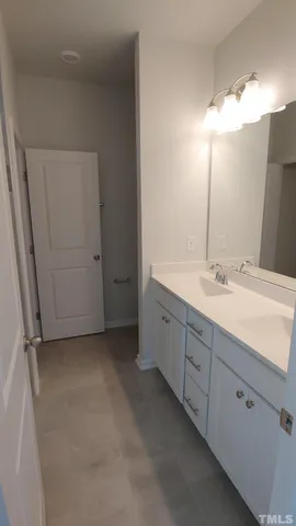 a bathroom with a double vanity sink and a mirror