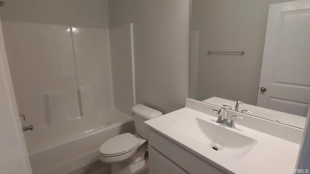a bathroom with a sink toilet and a mirror