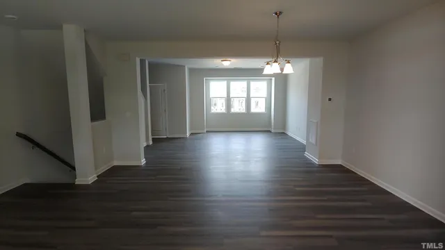 a view of a room with wooden floor and windows