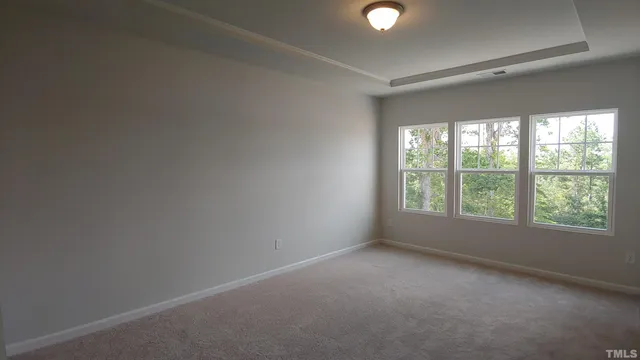 an empty room with windows and yard
