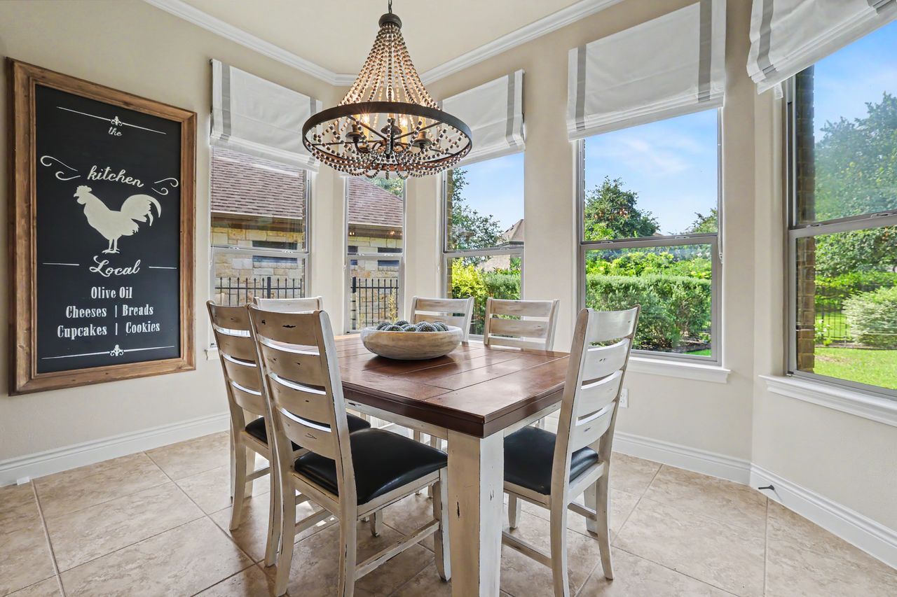 809 Prairie Dunes Drive Georgetown, TX 78628 - Photo 11 of 40 A charming dining space with abundant natural light, offering views of the lush outdoor greenery.