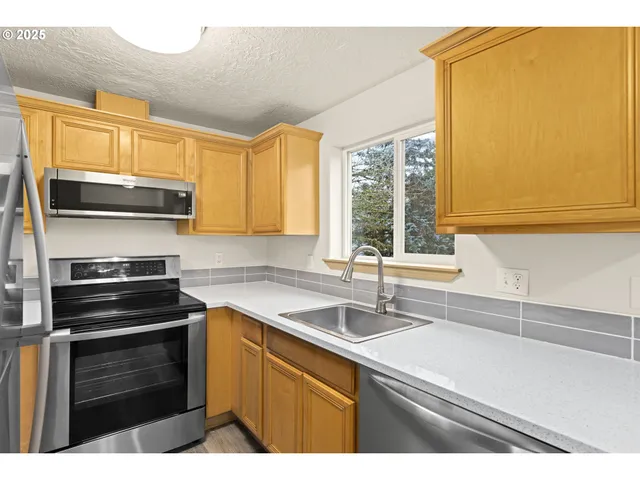 a kitchen with a sink stove and microwave