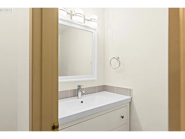 a bathroom with a sink and mirror
