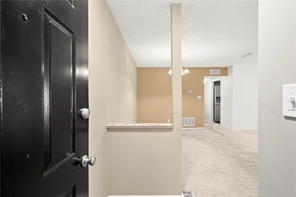 a view of a room with a chandelier fan