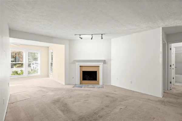 a view of empty room with a fireplace