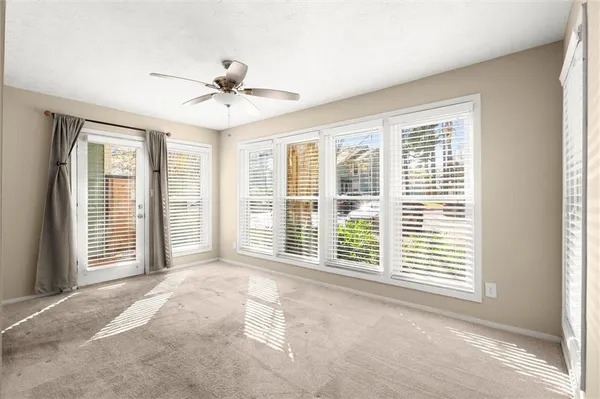 a view of a livingroom with a ceiling fan and window