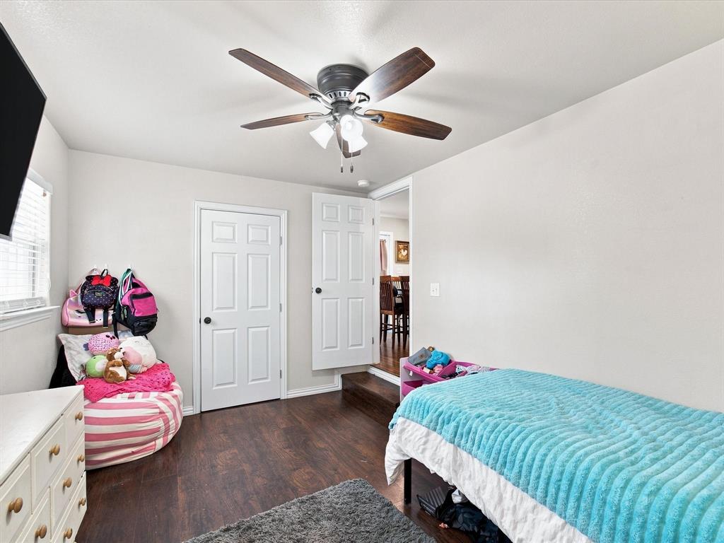 408 Inwood Road Azle, TX 76020 - Photo 26 of 32 Recessed window with blinds, wood-finish flooring, two panel doors, and a ceiling fan with light fixture