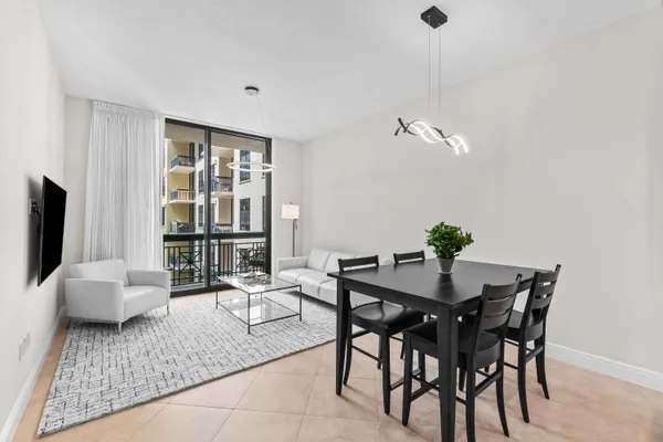 a living room with furniture and kitchen view