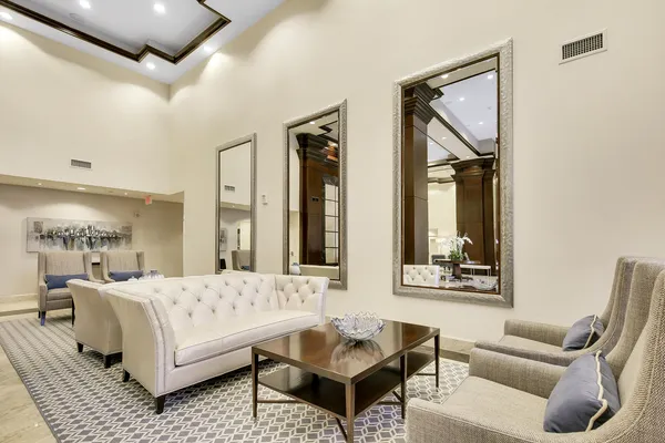 a living room with furniture and a lamp