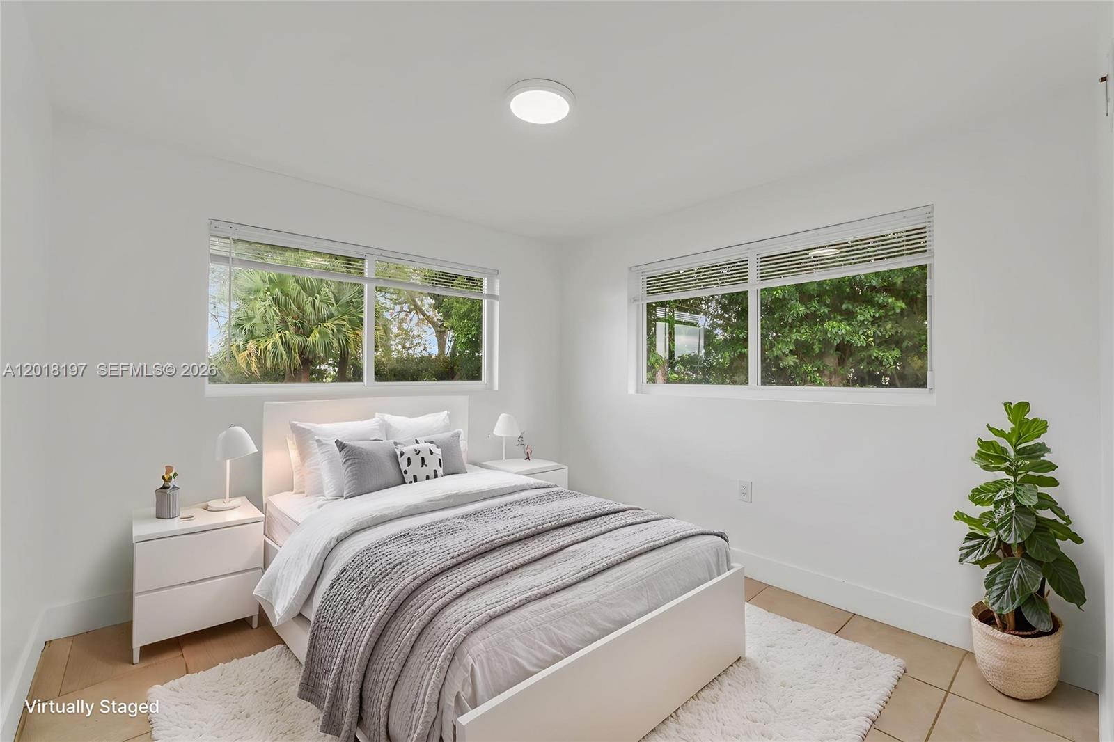 628 Southwest 8th Avenue Homestead, FL 33030 - Photo 20 of 25 a bedroom with a bed and a potted plant