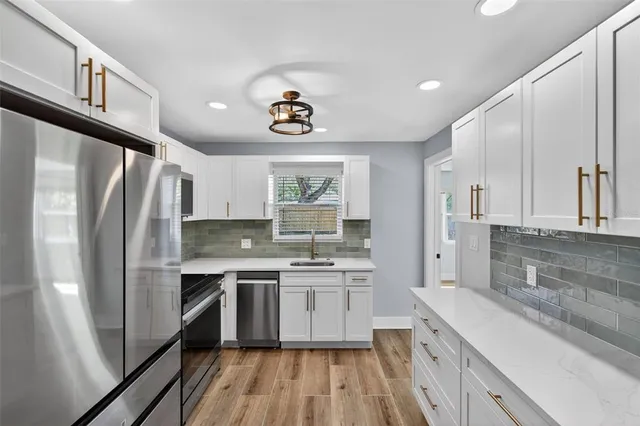 a view of empty room with wooden floor and ceiling fan