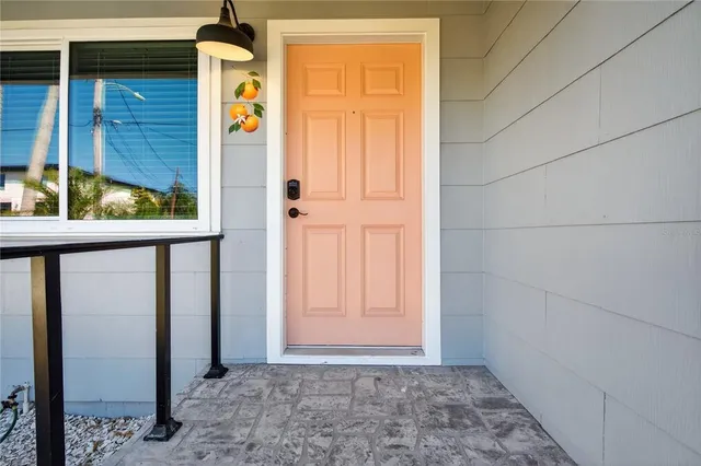 a view of a kitchen with white cabinets and wooden floor