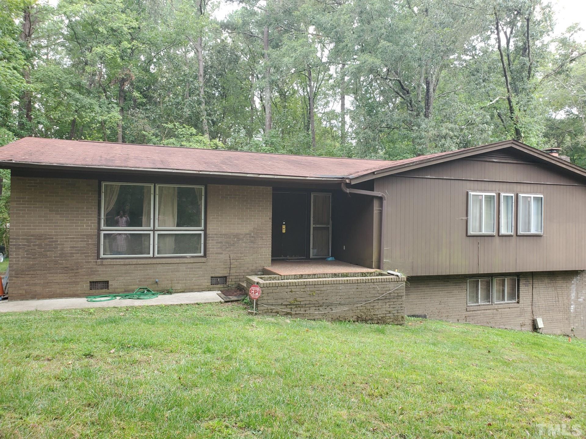 5832 Sandstone Drive Durham, NC 27713 - Photo 1 of 3 a backyard of a house with seating space