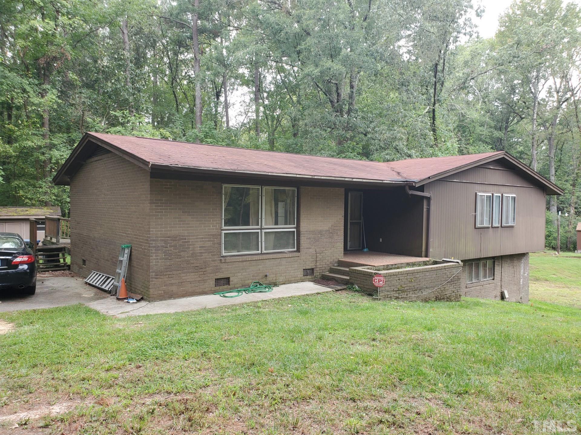 5832 Sandstone Drive Durham, NC 27713 - Photo 2 of 3 a backyard of a house with table and chairs