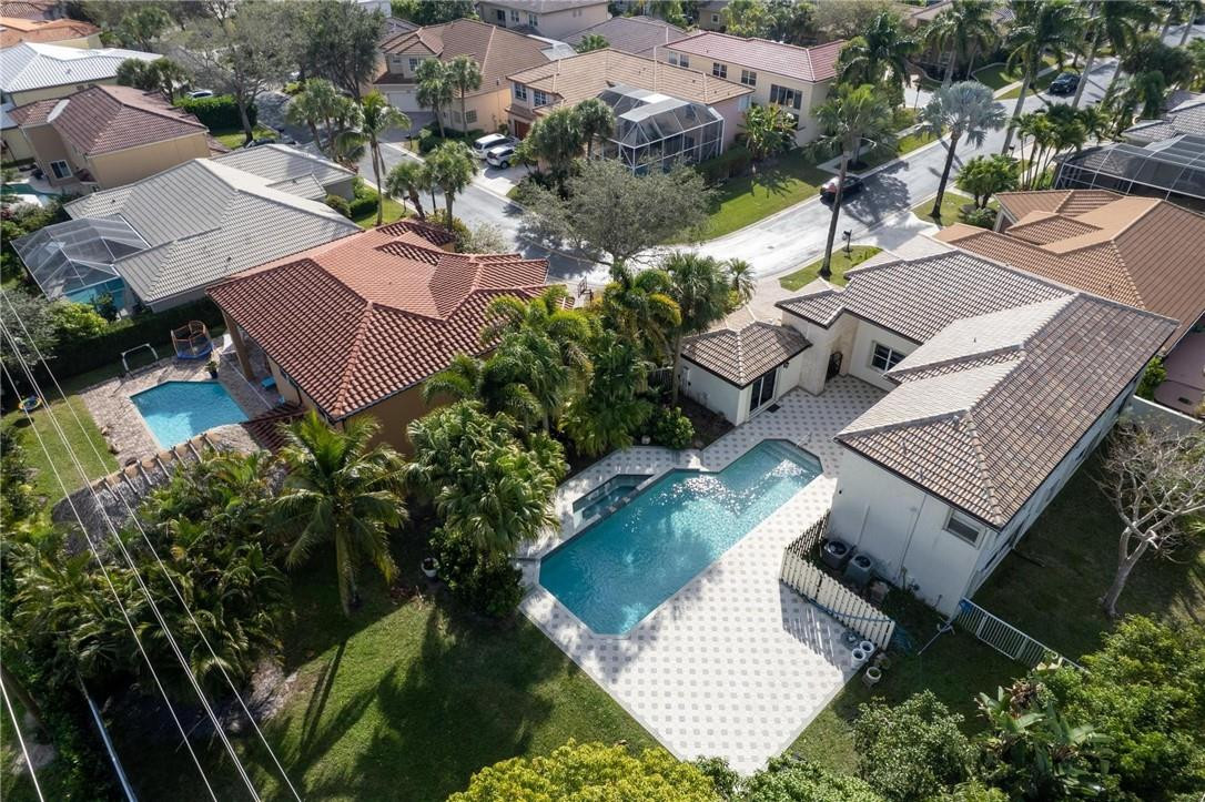 10945 Ravel Court Boca Raton, FL 33498 - Photo 22 of 24 an aerial view of a house with a garden