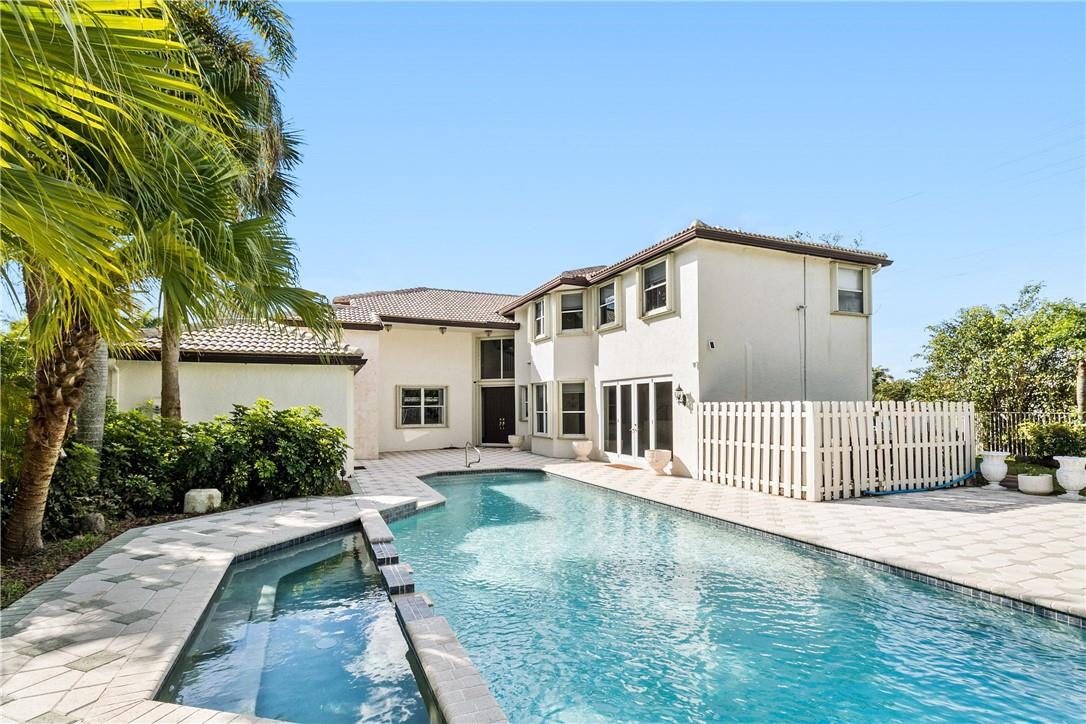10945 Ravel Court Boca Raton, FL 33498 - Photo 4 of 24 a front view of a house with a yard