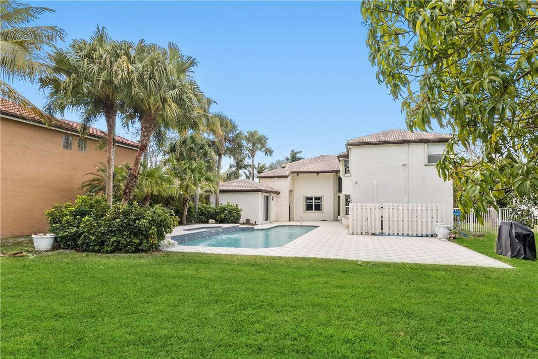 10945 Ravel Court Boca Raton, FL 33498 - Photo 5 of 24 a front view of a house with garden