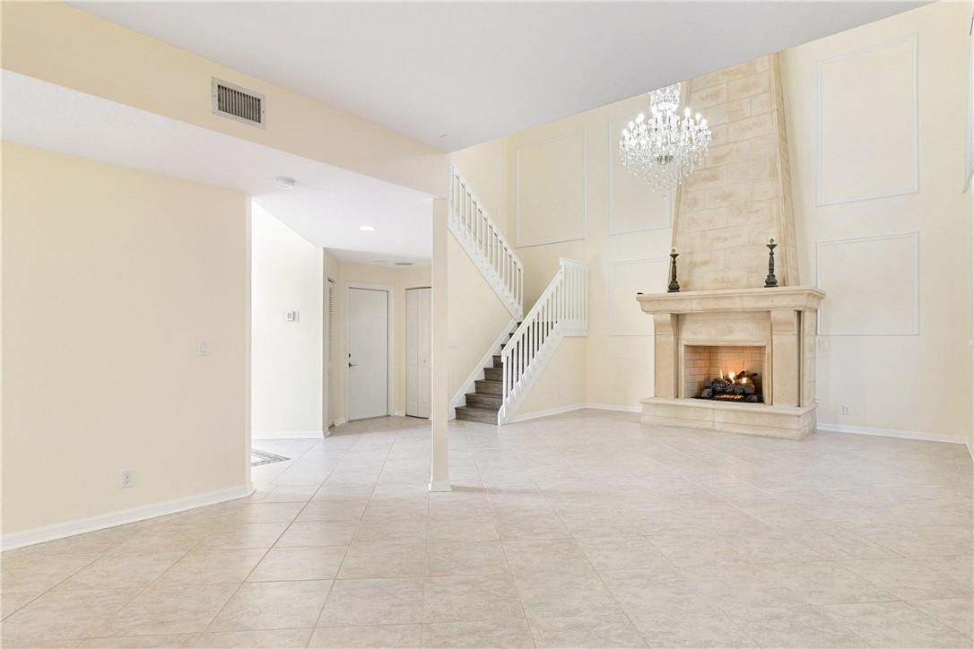 10945 Ravel Court Boca Raton, FL 33498 - Photo 8 of 24 a view of an empty room with chandelier fan and fire place