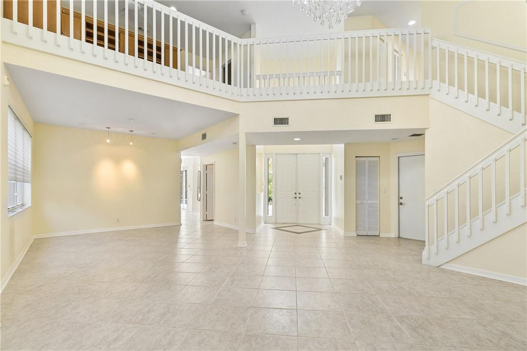 10945 Ravel Court Boca Raton, FL 33498 - Photo 9 of 24 a view of an entryway with wooden floor