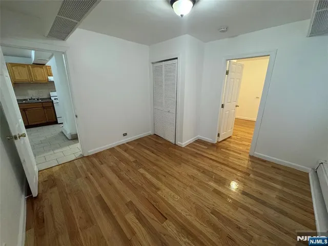 a view of hallway with wooden floor