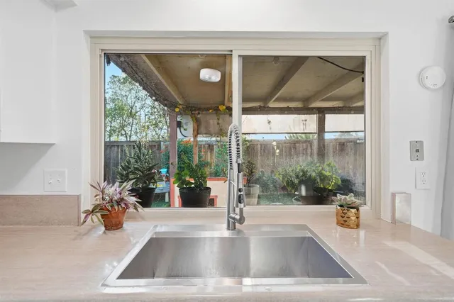 a view of a living room and dining room with a large window