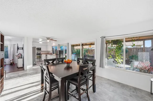 a view of a dining room with furniture and window