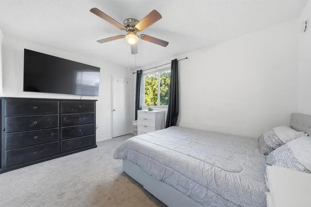 a bedroom with a bed and a television