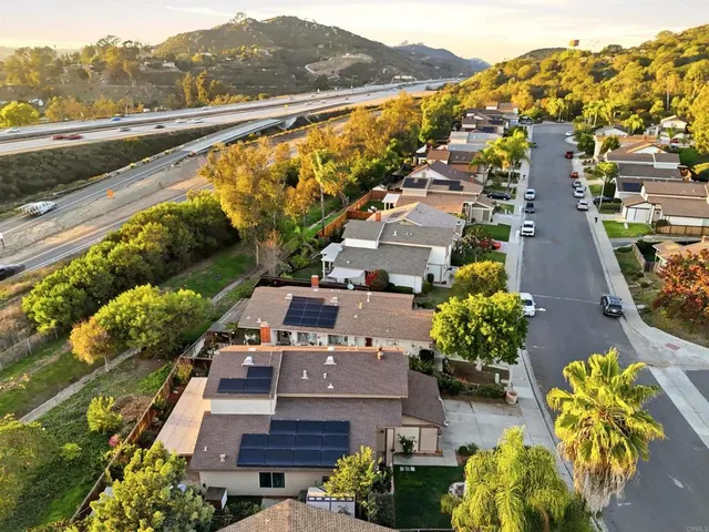 an aerial view of residential houses with outdoor space