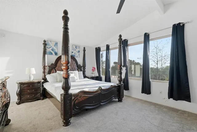 a bedroom with bed and glass door