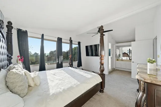 a bed sitting in a room next to a window