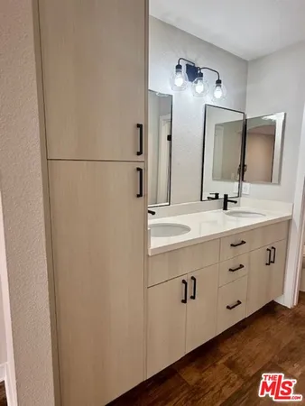 a bathroom with a double vanity sink and mirror