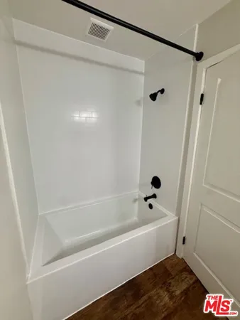 a bathroom with a bathtub and shower