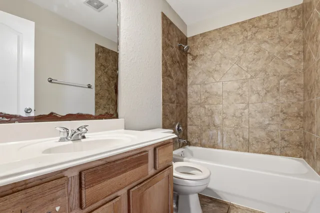 a bathroom with a sink a toilet and a bathtub