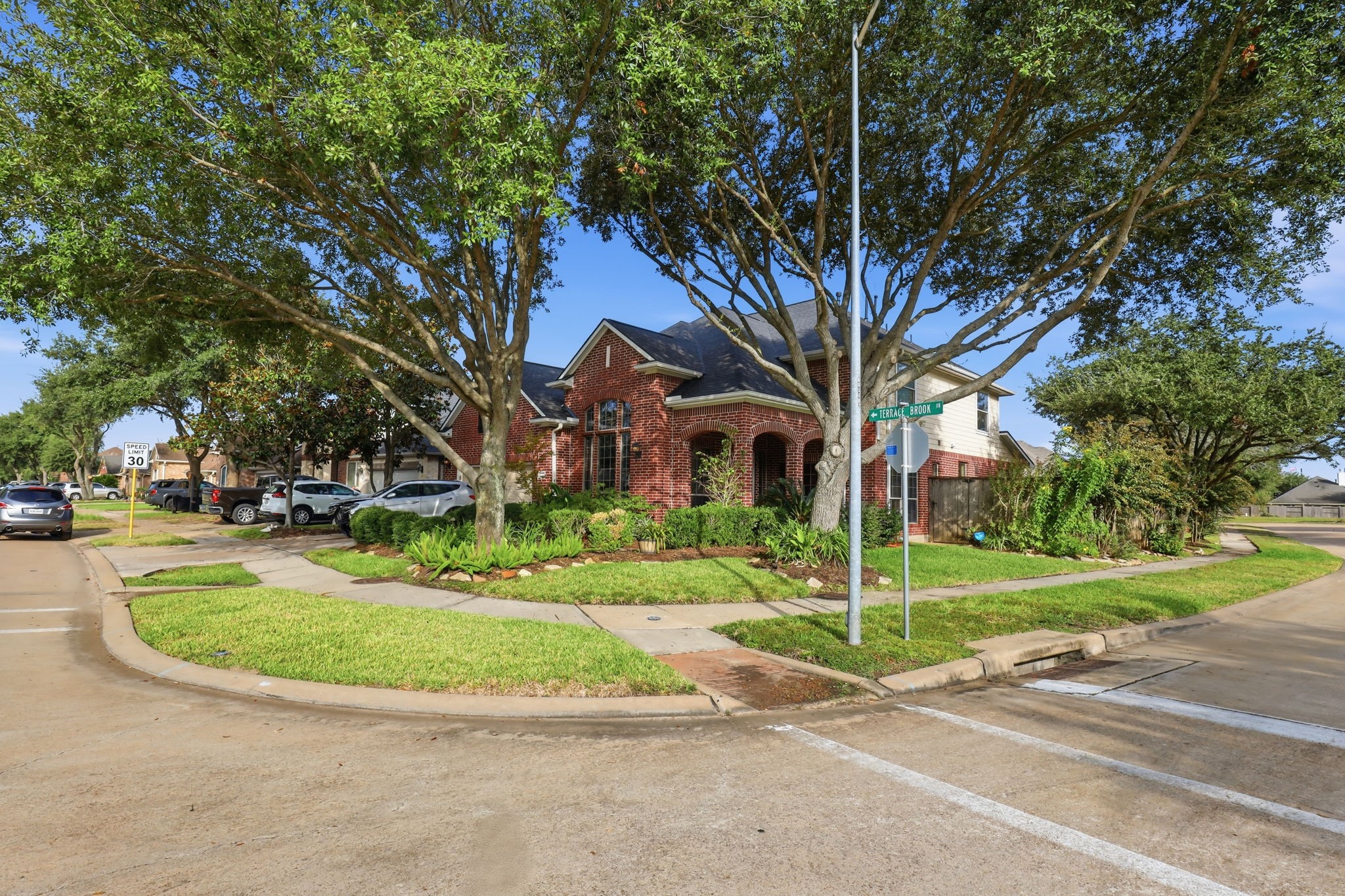 8202 Terrace Brook Drive Houston, TX 77040 - Photo 23 of 23 This stunning home, perfectly situated on a desirable corner lot, offers expansive outdoor space and enhanced privacy, framed by lush greenery and charming curb appeal.