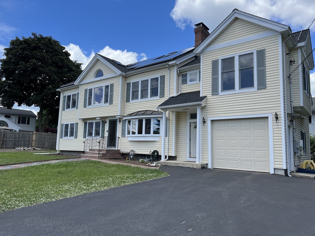 11 Garrison Road, Unit 1 Arlington, MA 02474 - Photo 1 of 42 a house view with a garden space