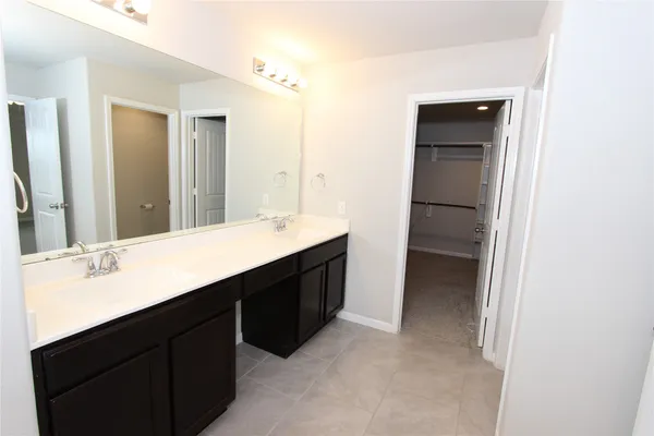 a bathroom with a double vanity sink a and mirror