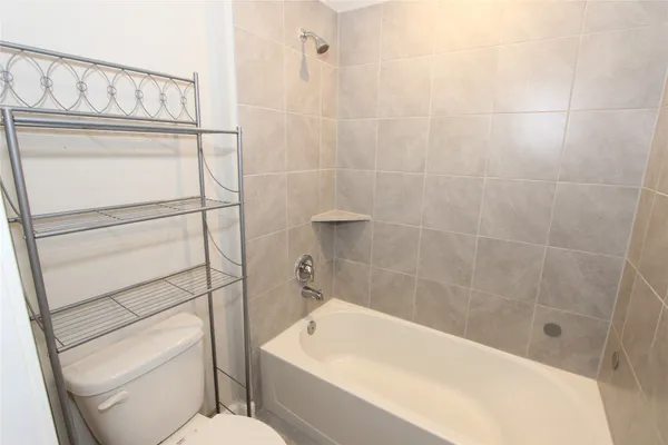 a bathroom with a shower a toilet and sink