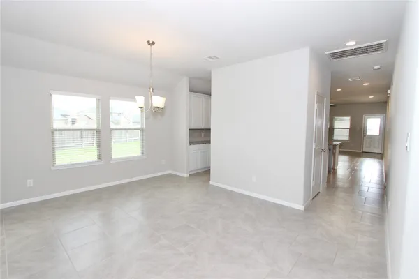 an empty room with windows and entrance