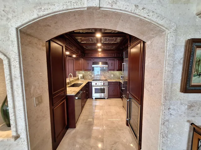 a large kitchen with a stove and a refrigerator