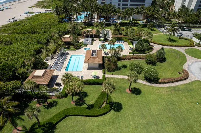 an aerial view of a house with yard swimming pool and outdoor seating