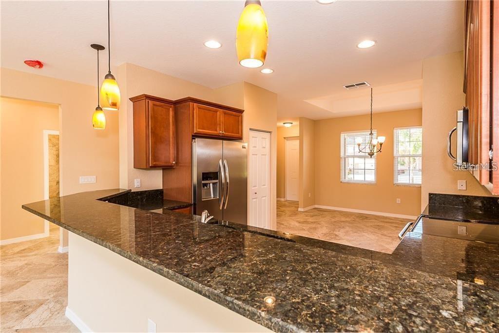 3948 San Rocco Drive, Unit 112 Punta Gorda, FL 33950 - Photo 6 of 18 a kitchen with refrigerator and window