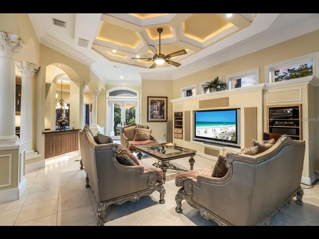 a living room with fireplace furniture and a flat screen tv