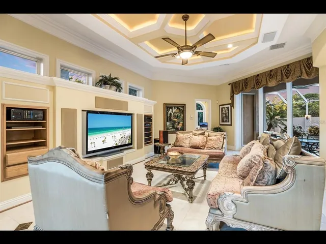 a living room with furniture a chandelier and a fireplace