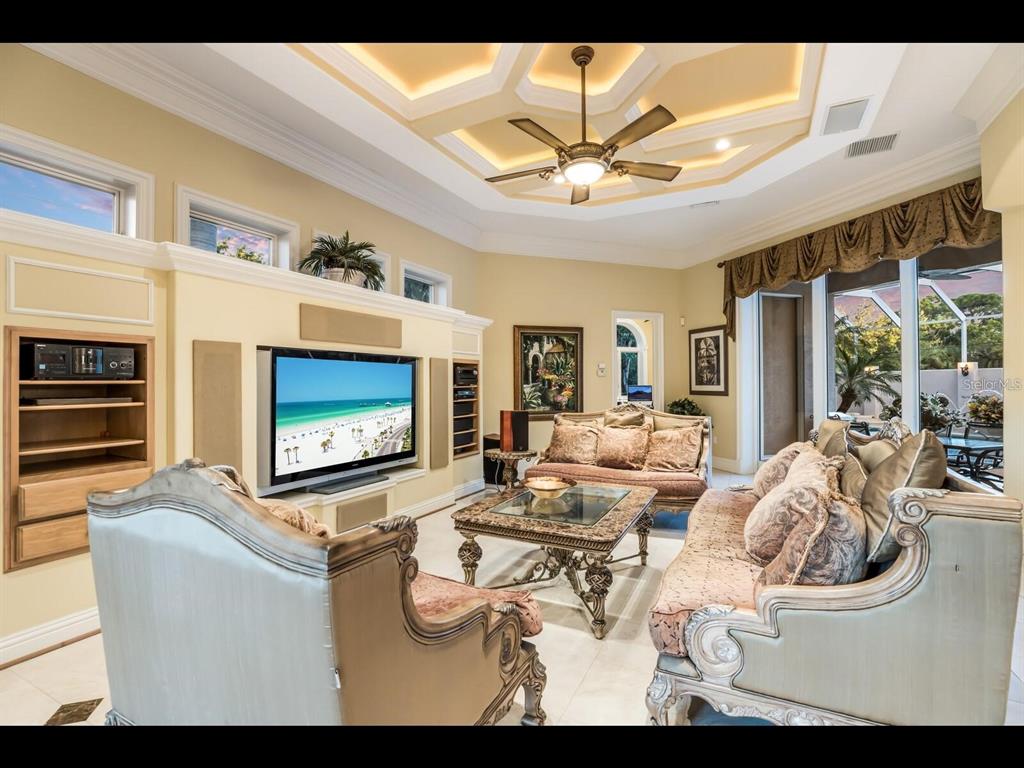 1102 Horizon View Drive Sarasota, FL 34242 - Photo 12 of 56 a living room with furniture a chandelier and a fireplace