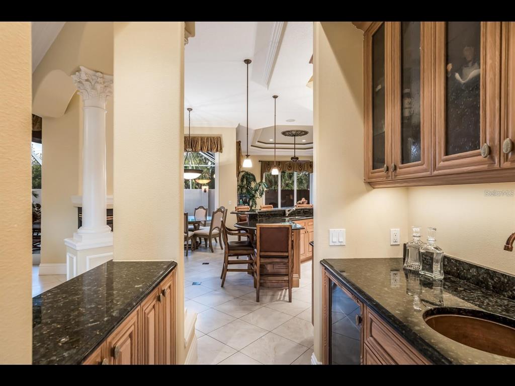 1102 Horizon View Drive Sarasota, FL 34242 - Photo 16 of 56 a kitchen with granite countertop a sink and a stove